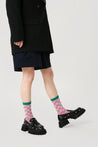 Elegant black coat and matching pink socks from the women's set