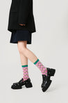 Chic pink socks from the set, paired with sleek black boots