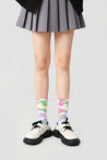 Vibrant, patterned socks from the set, paired with a feminine skirt