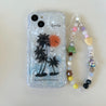 A stylish phone case with a coconut tree and phone chain compatible with iPhone 14 Pro Max