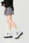 Fashionable striped socks from the set, worn with a skirt