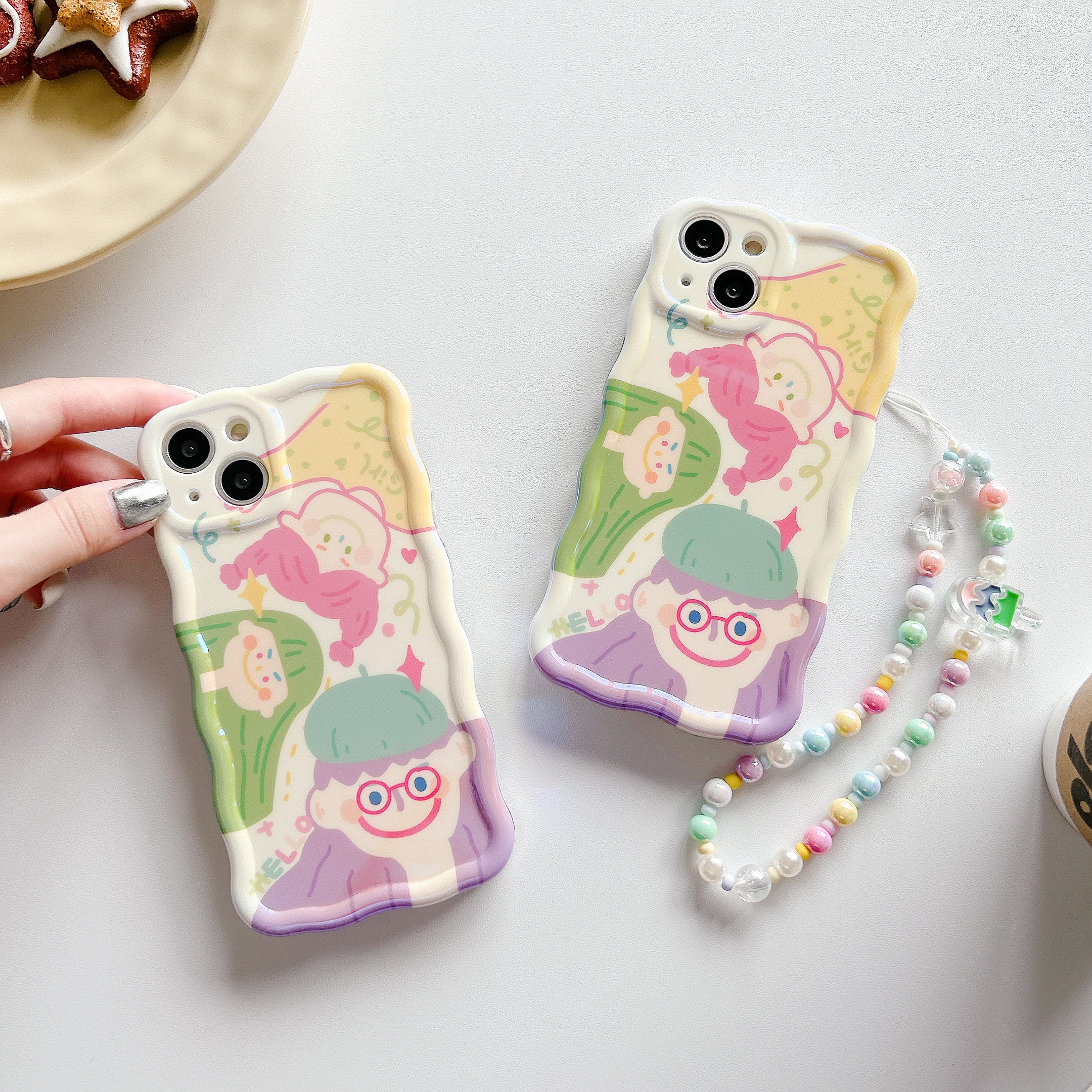 Duo of Korean fashion-inspired iPhone cases with cute character illustrations