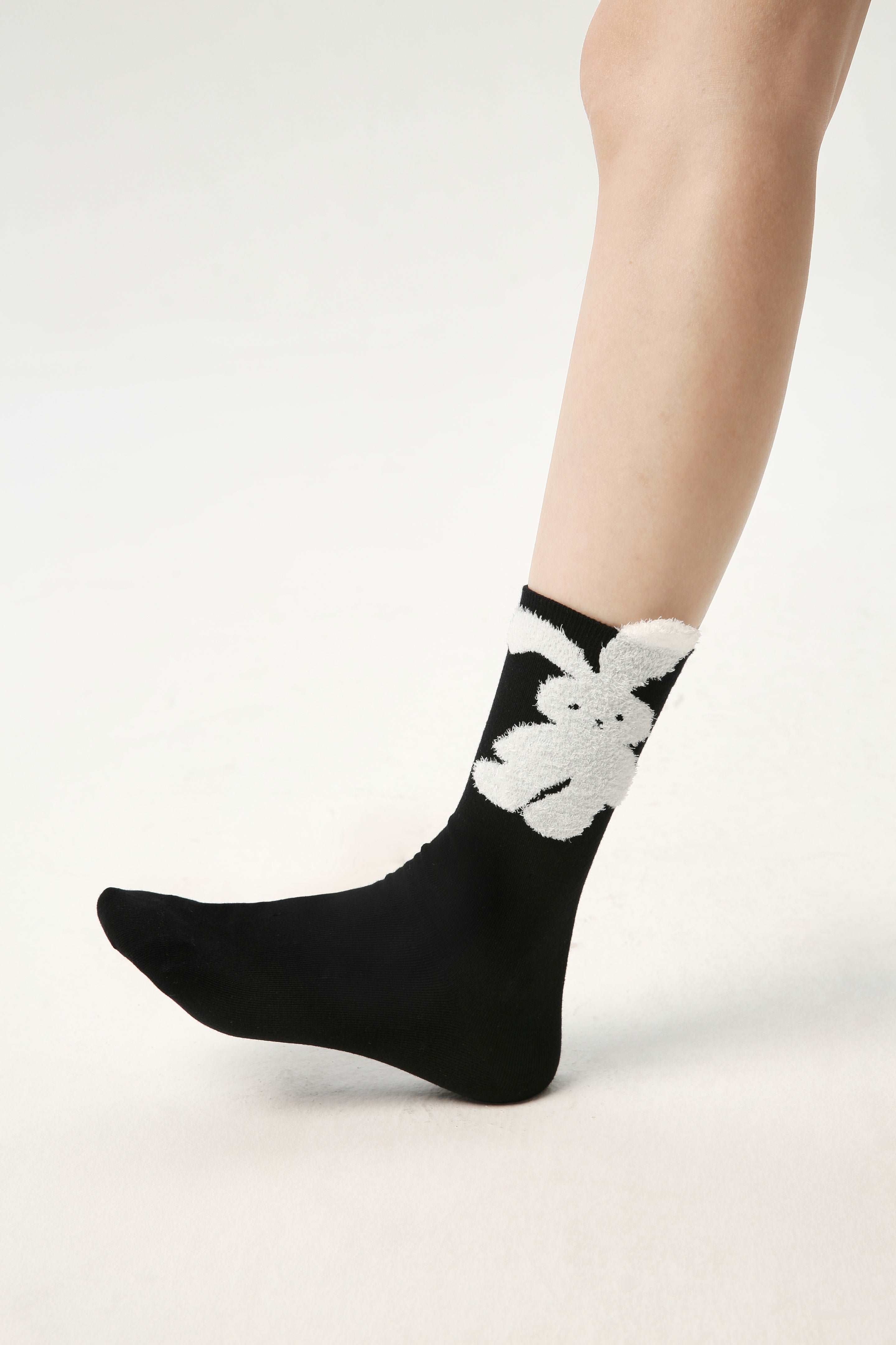 Black socks with a delicate white rabbit pattern from the women's cute sock collection