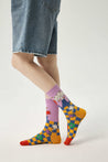 A woman's legs clad in a pair of socks from the set, adorned with colorful Y2K-inspired cartoon graphics