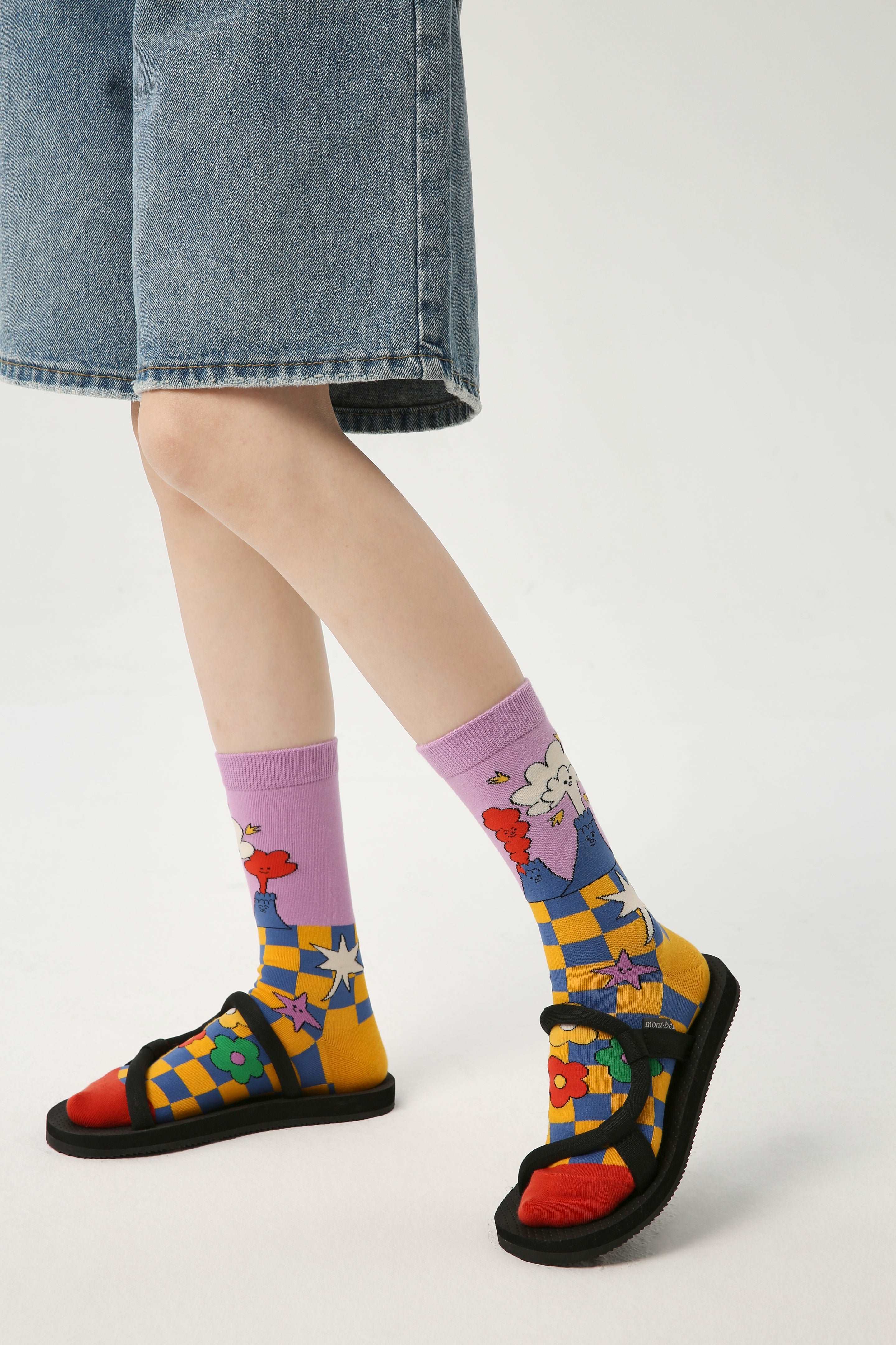 Woman's feet in sandals, accentuated by colorful socks from the Y2K fashion set