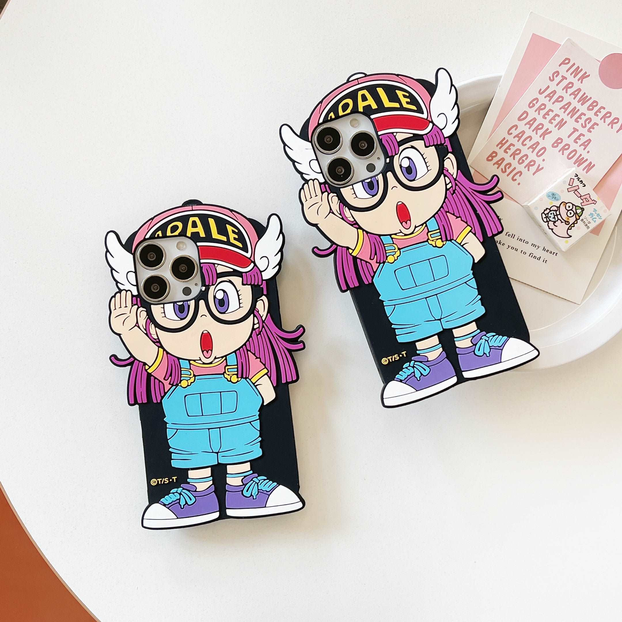 Pair of iPhone cases showcasing Arale with glasses in a cute design