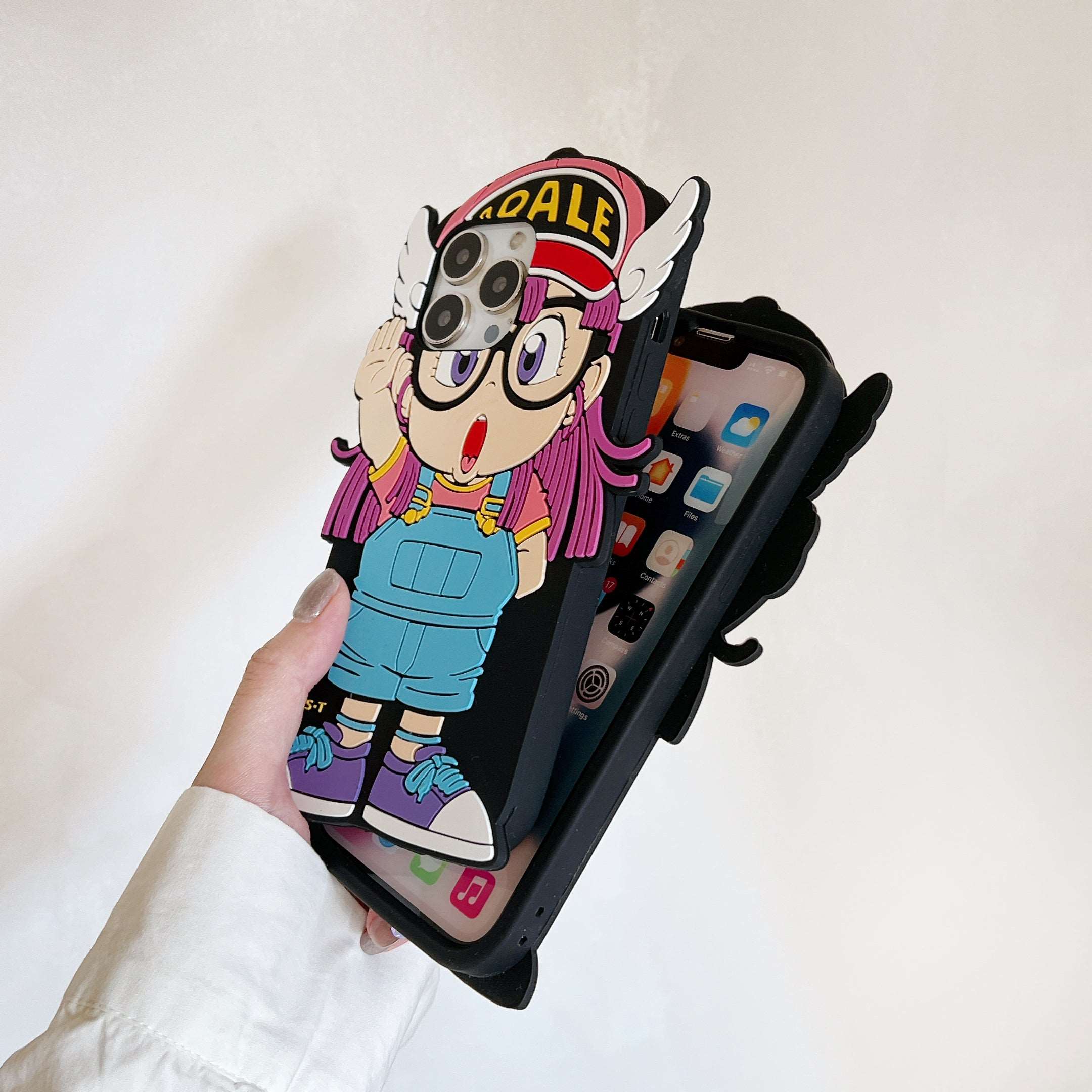 User displaying a kawaii Arale character iPhone case for the latest iPhone models