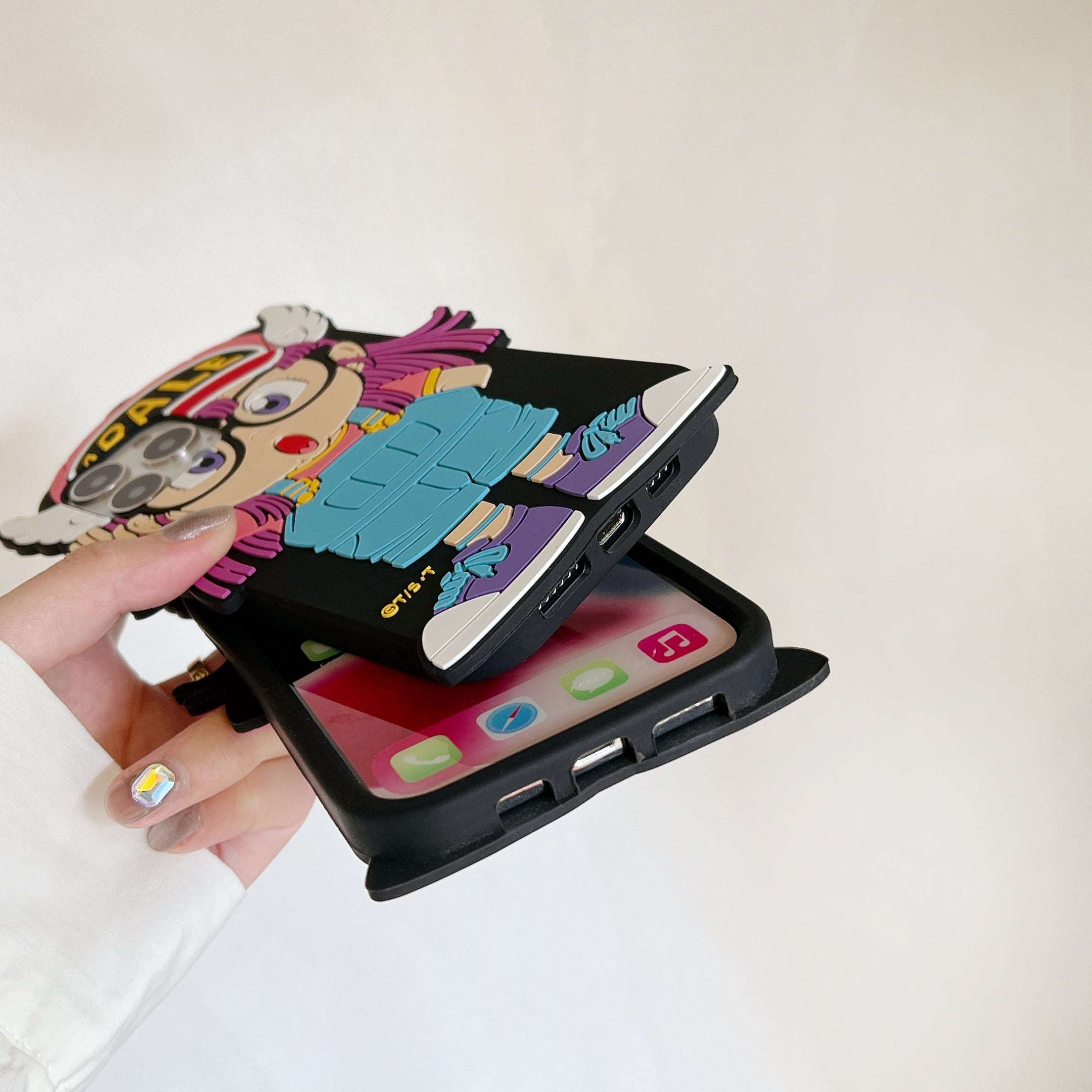 Individual showcasing an Arale-themed silicone iPhone case from Dr. Slump