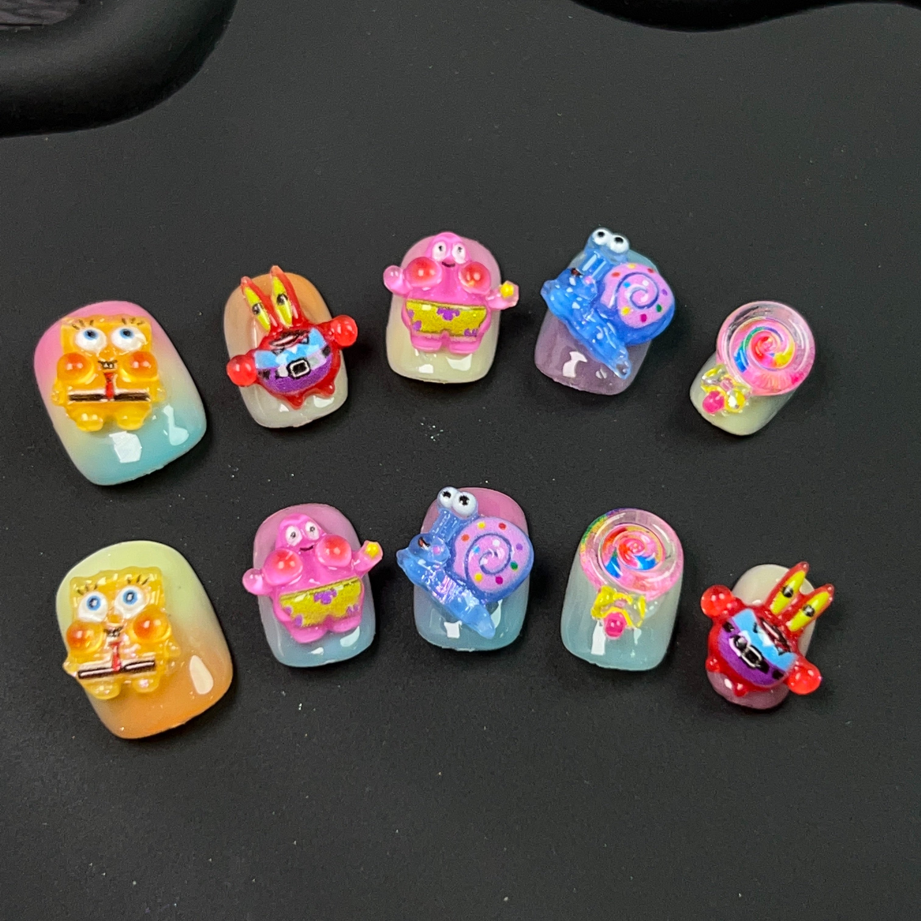 Collection of Sponge Bob inspired nail art designs displayed