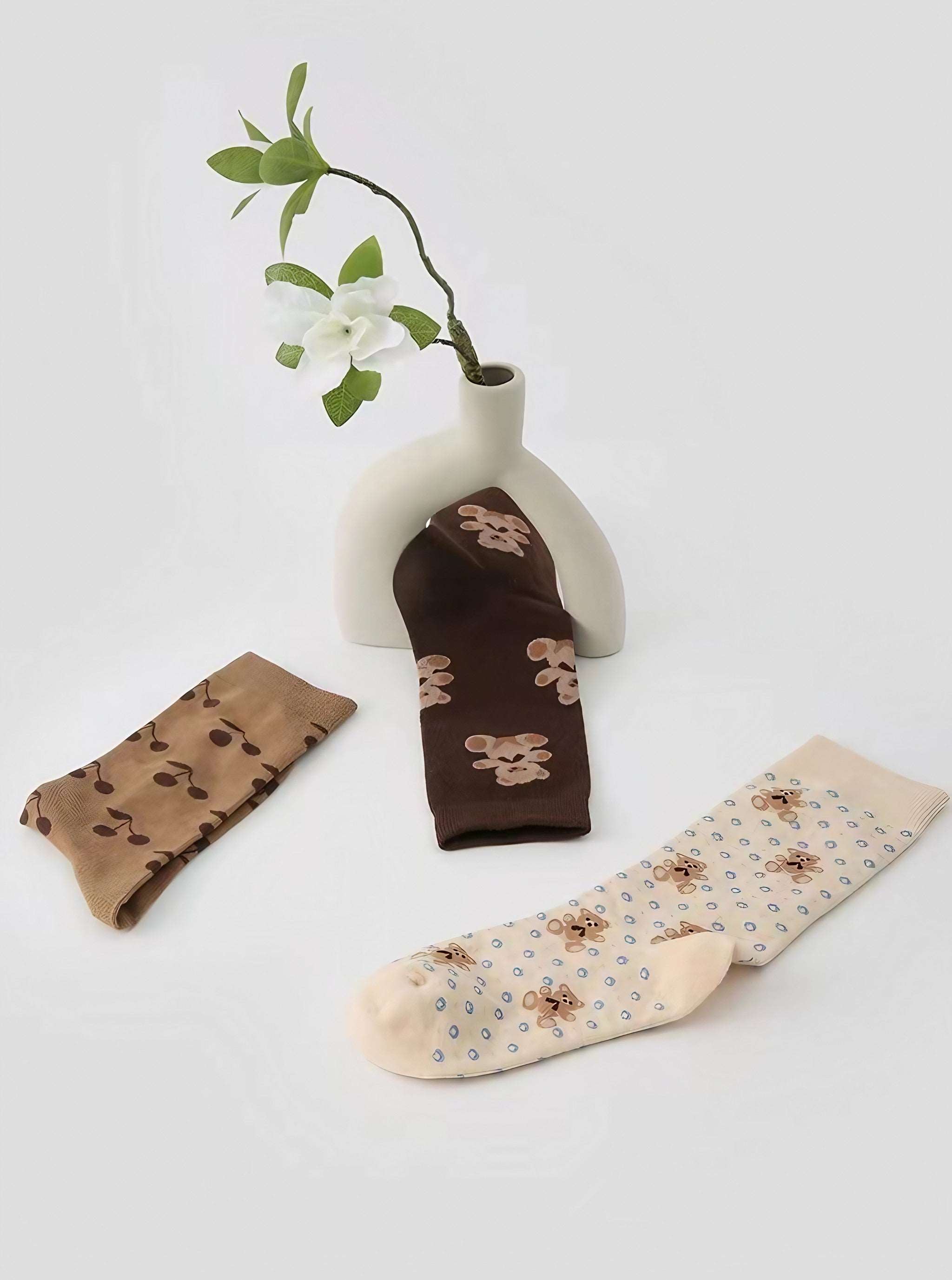 Variety display of the Brown Bear Socks set with bear and cherry designs