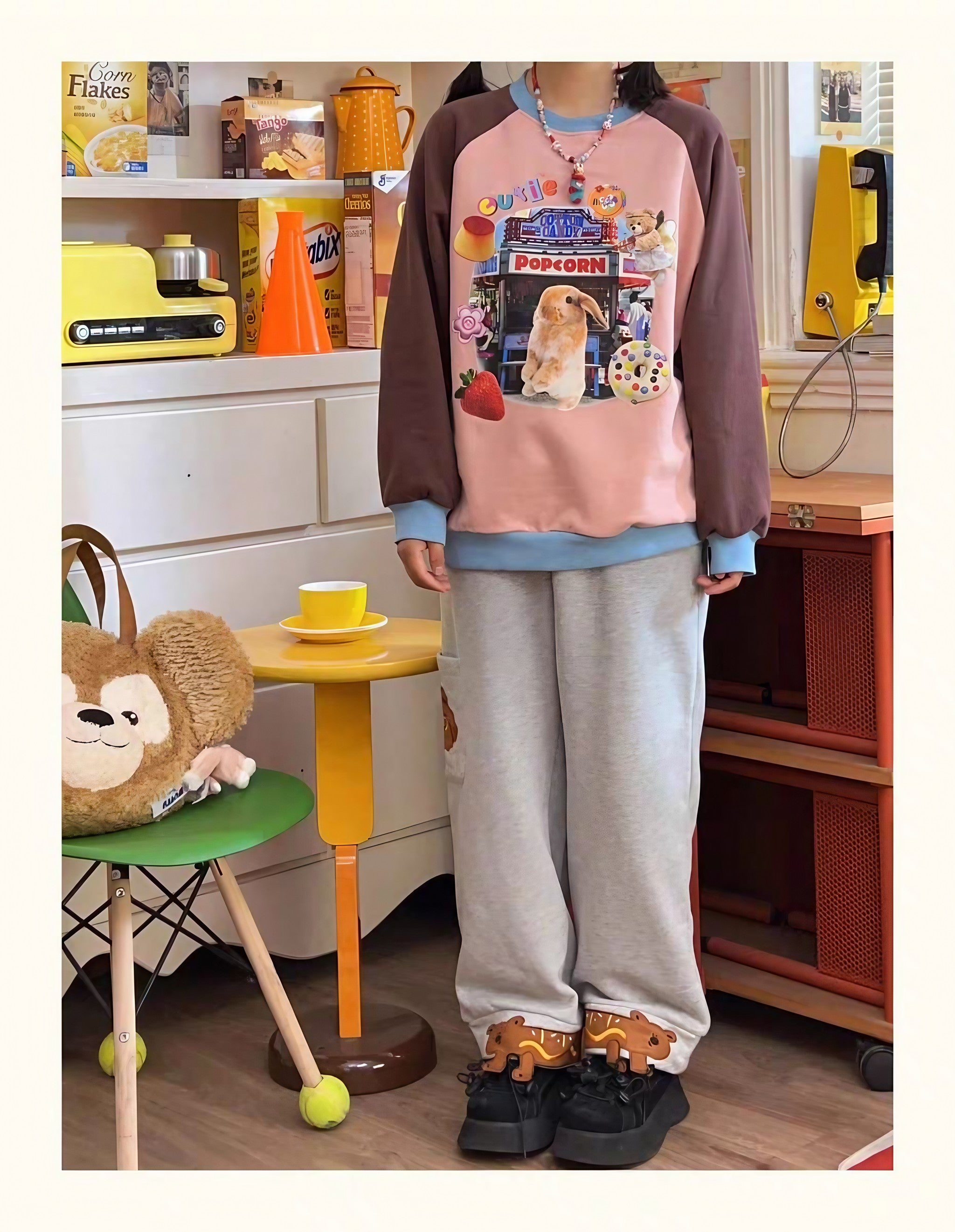 A girl in a Gen Z aesthetic sweatshirt showcasing a playful cartoon bunny print