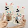 Model presenting White Rabbit cases for iPhone 13 Pro and 14 Pro Max