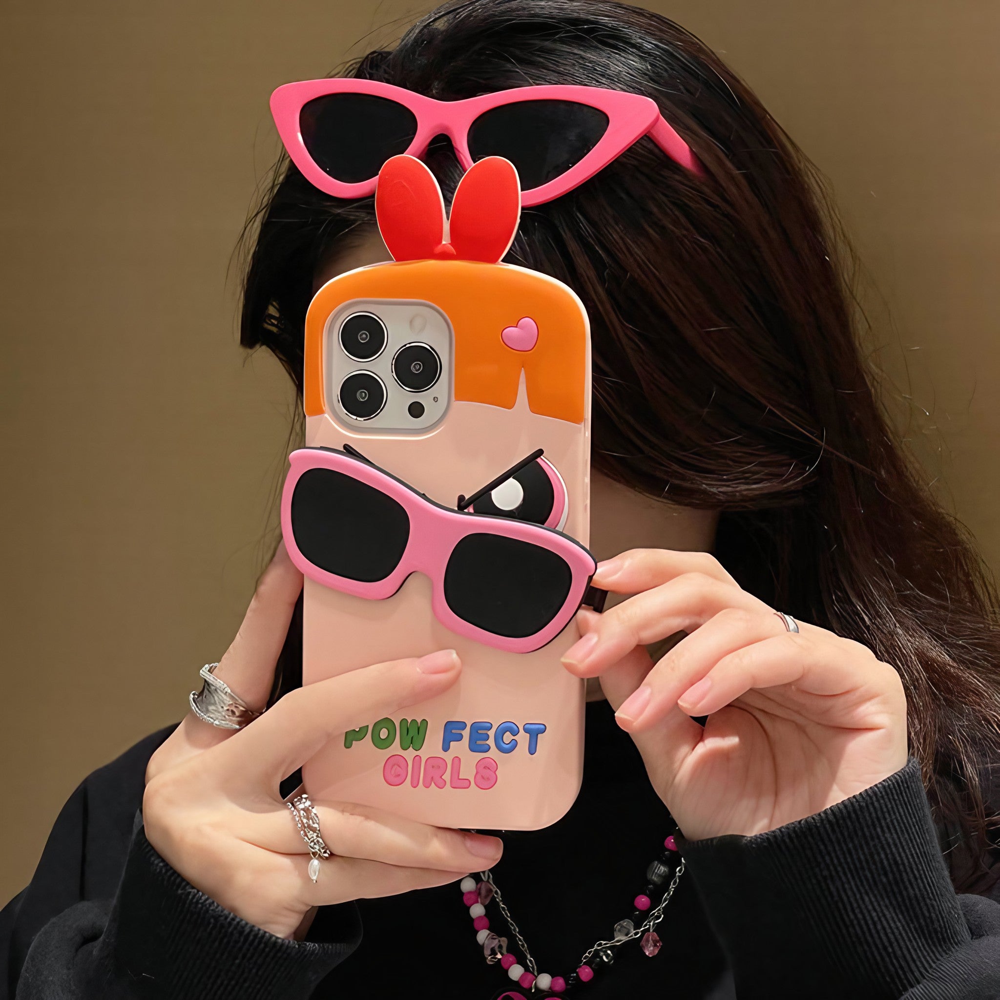 Fashionable presentation of a pink Powerpuff Girls iPhone case with sunglasses accessory