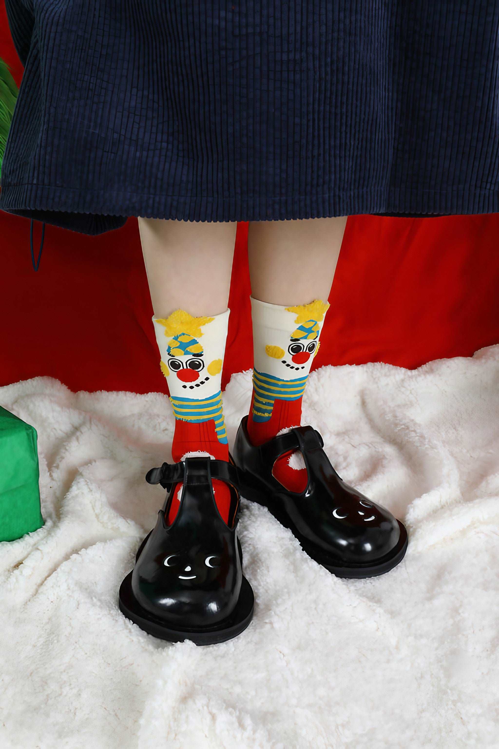 Seasonal socks with a red and yellow snowman pattern for winter wear