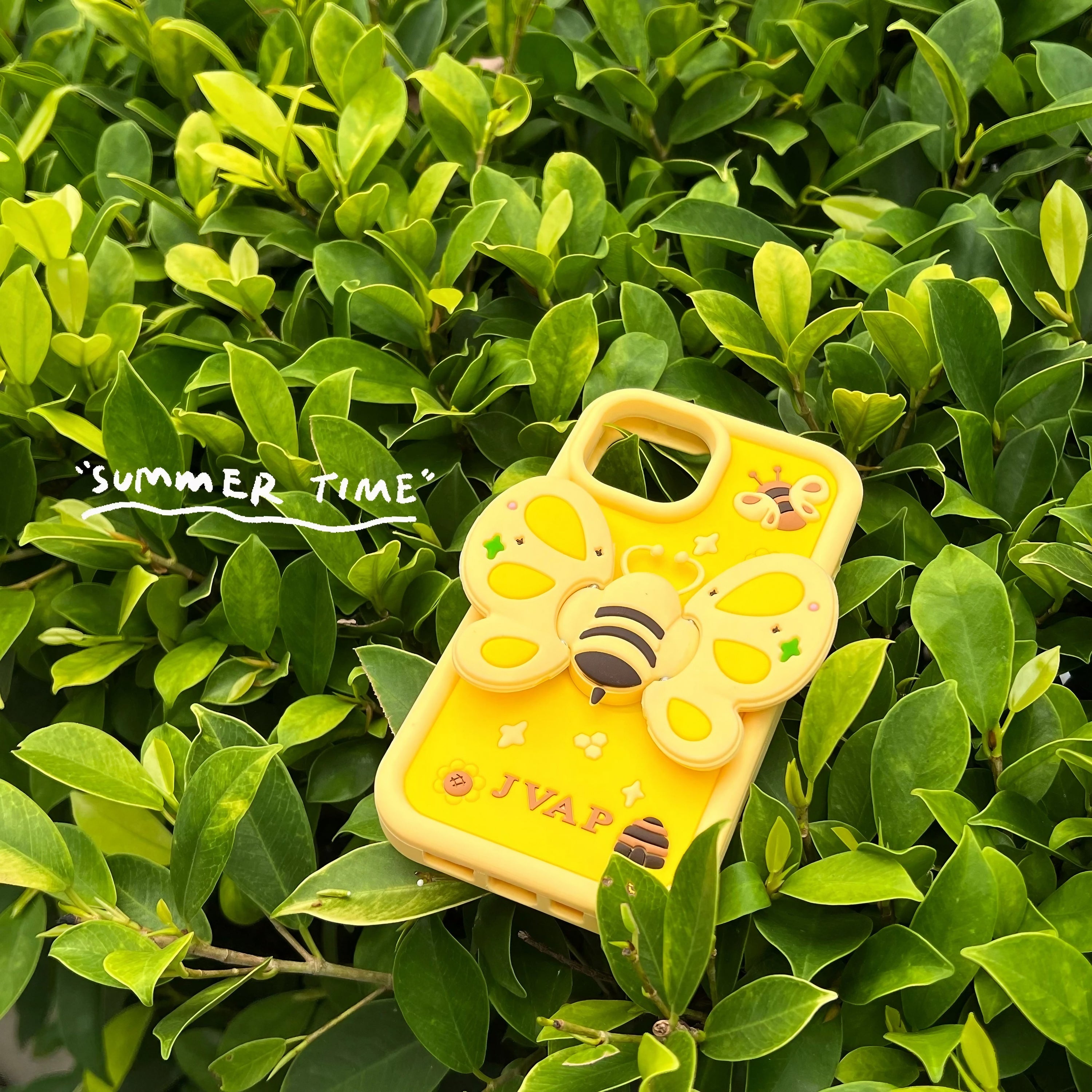 A yellow silicone iPhone case featuring a bumble bee design, compatible with iPhone 14 series and 13 Pro Max, with an integrated phone stand