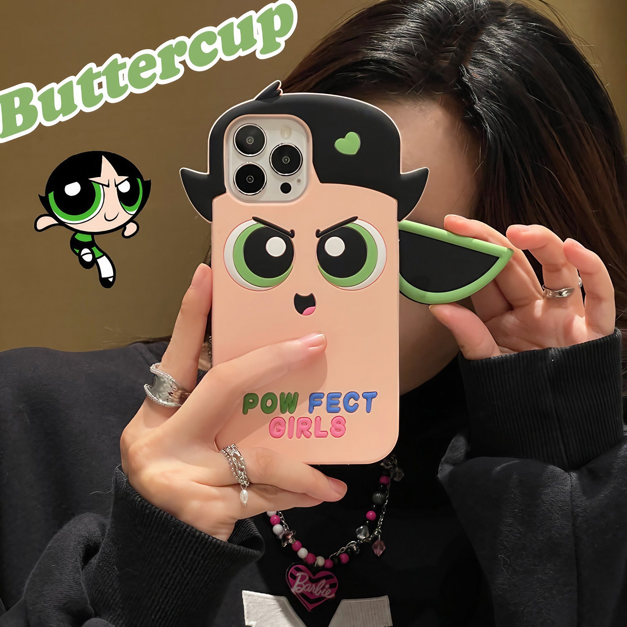 Person holding a new Powerpuff Girls iPhone case compatible with multiple iPhone versions