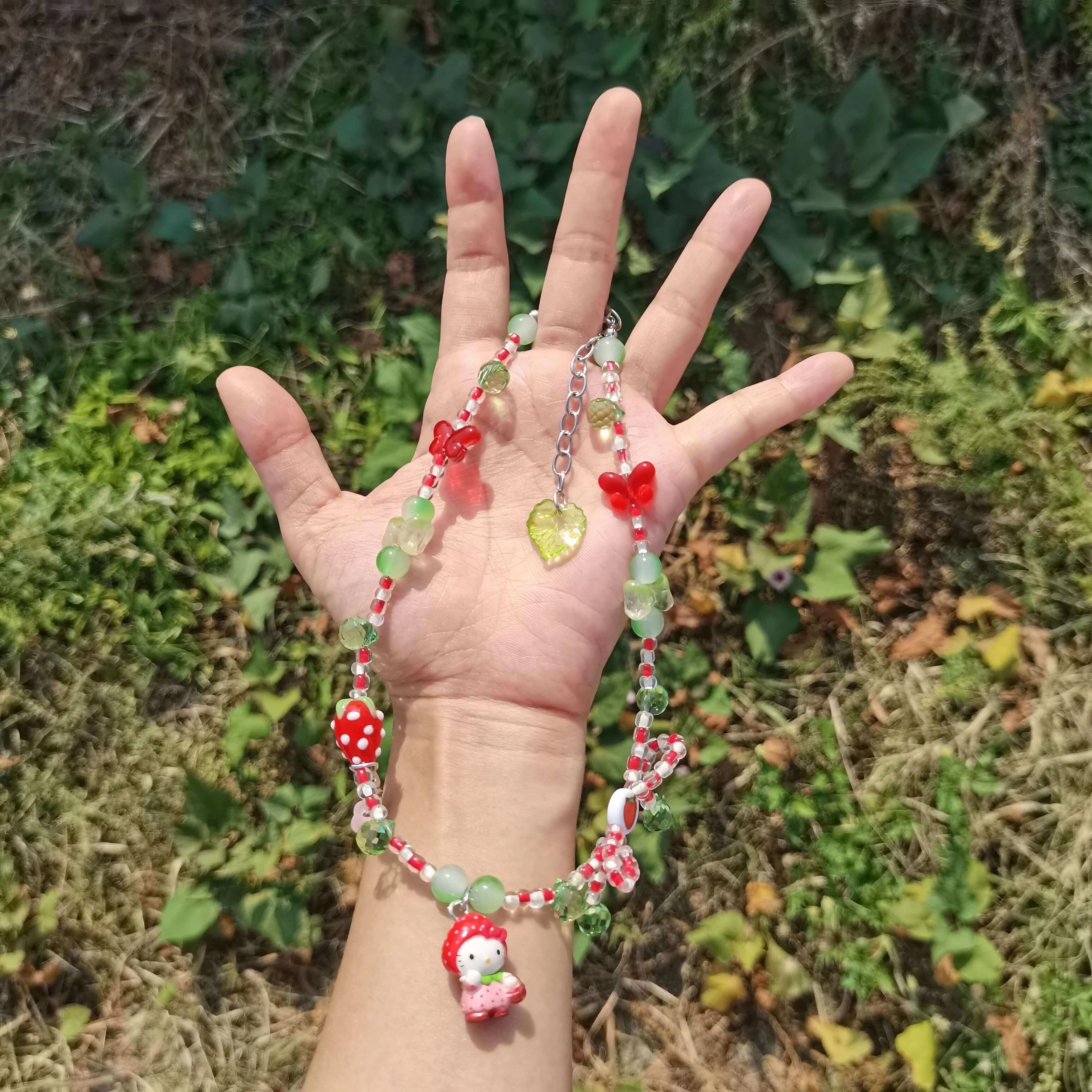 Model showcasing a unique red beaded Hello Kitty necklace