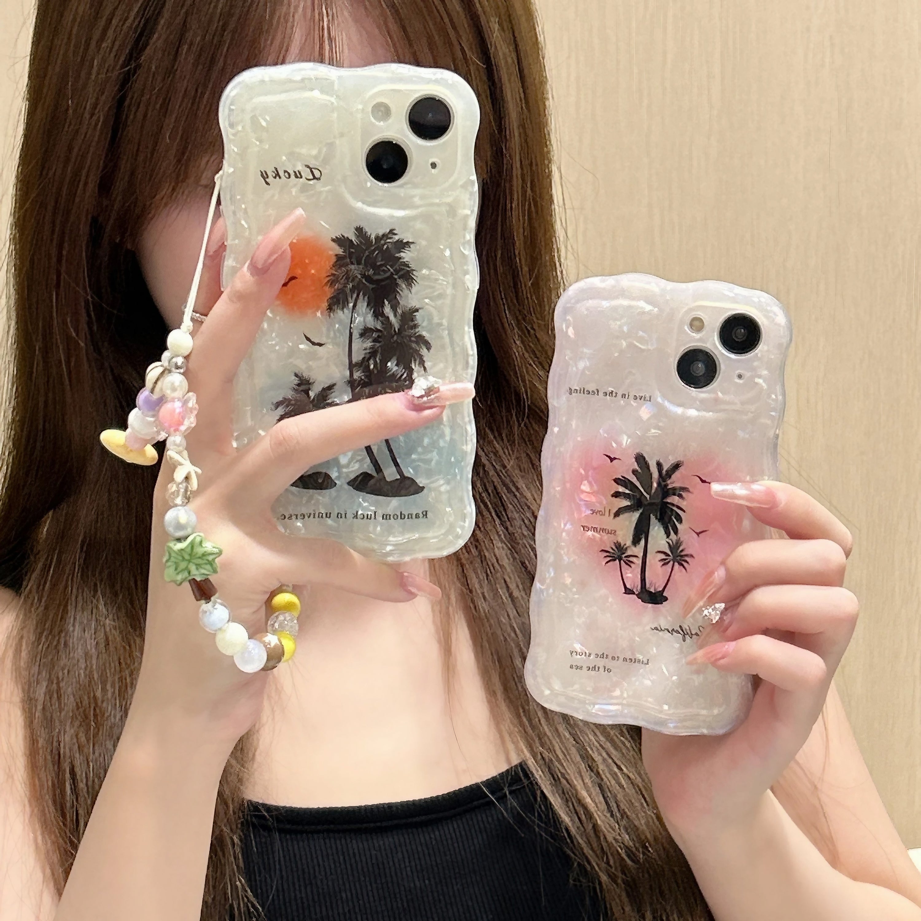 A woman presenting two iPhone 14 series soft TPU cases with coconut tree motifs