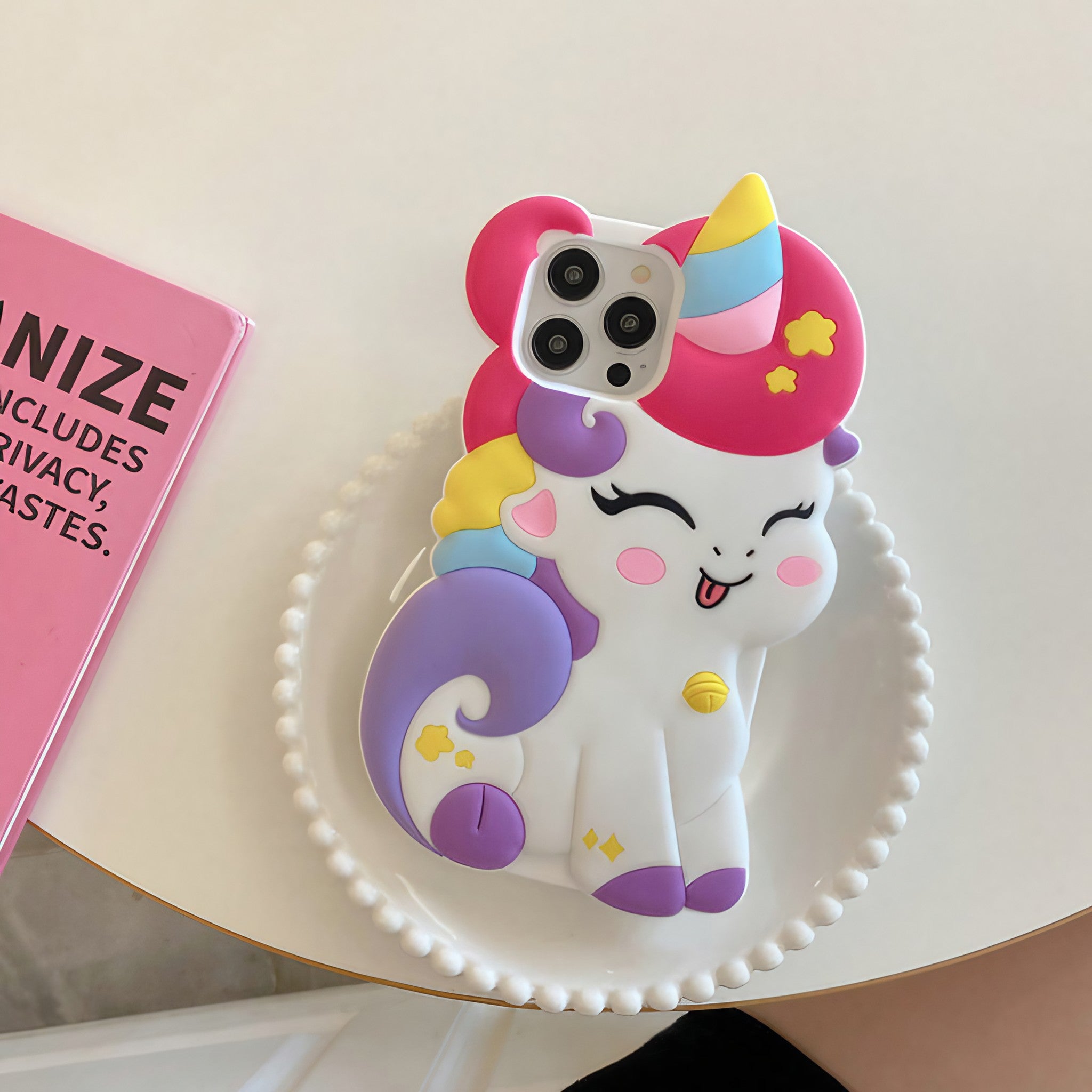 Rainbow unicorn iPhone case for various models on a pink and white backdrop