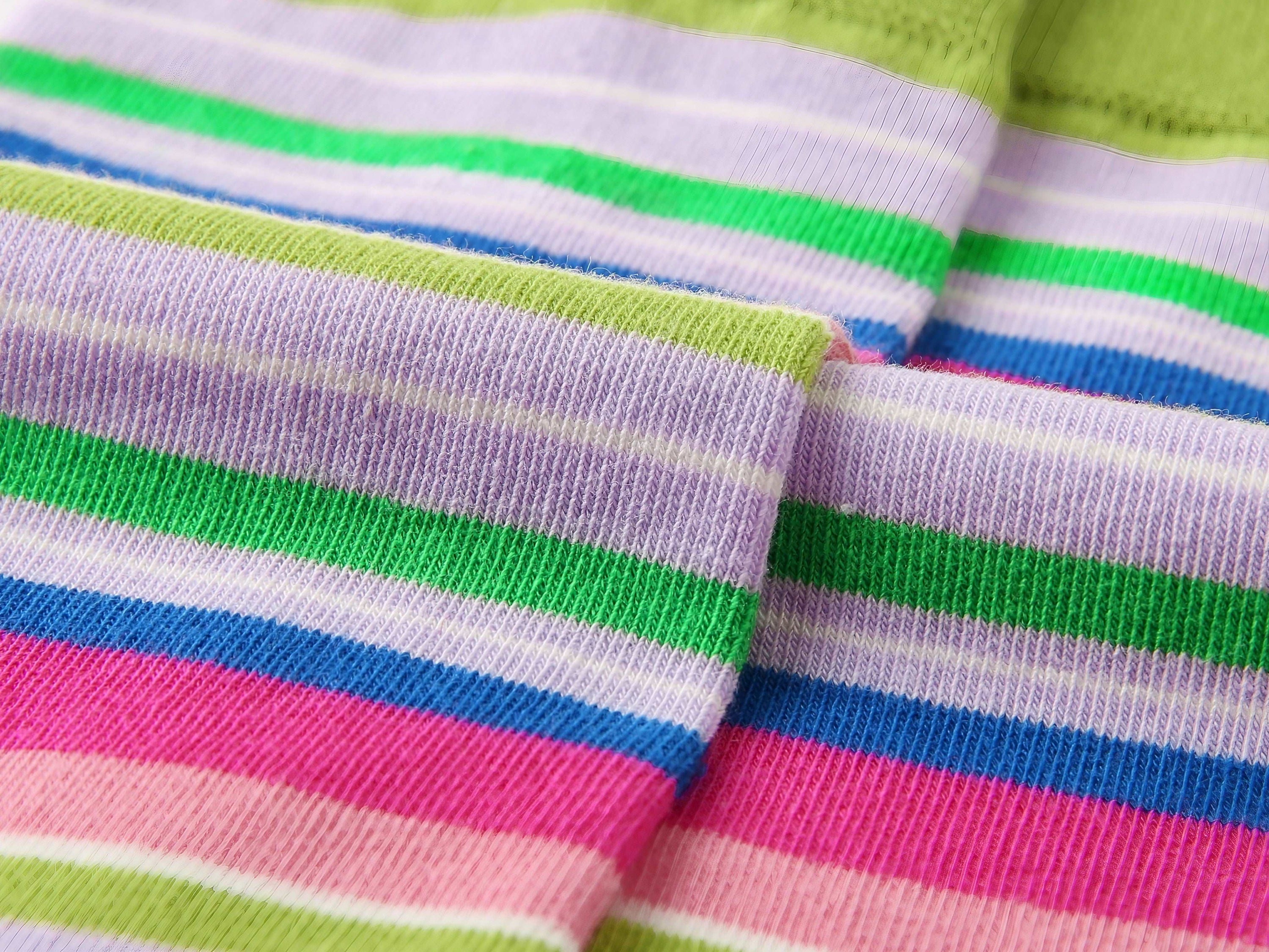 Detailed view of a sock with vibrant rainbow stripes
