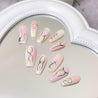 Heart-shaped mirror showcasing various Ballet Coquette press-on nails