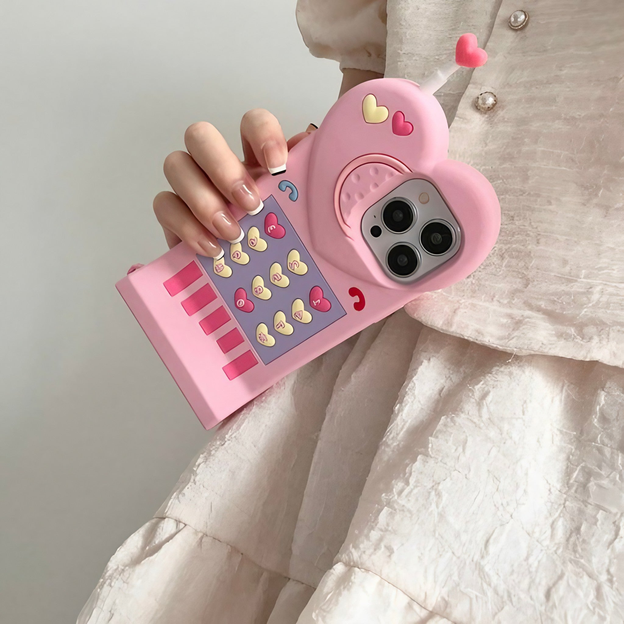 Woman showcasing a retro-style pink iPhone case with a heart-shaped detail