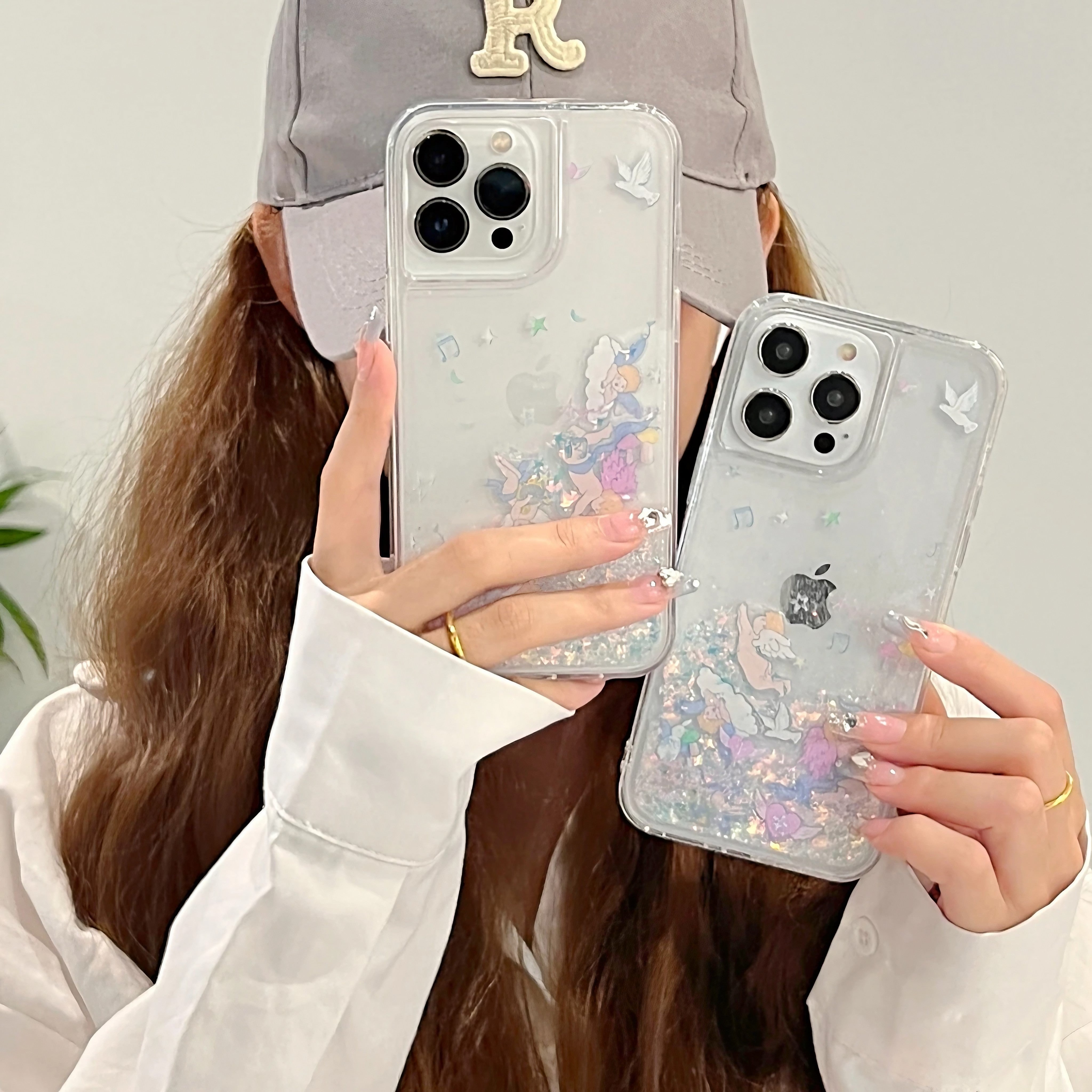 Female presenting two shimmering quicksand cases for iPhone 13 series