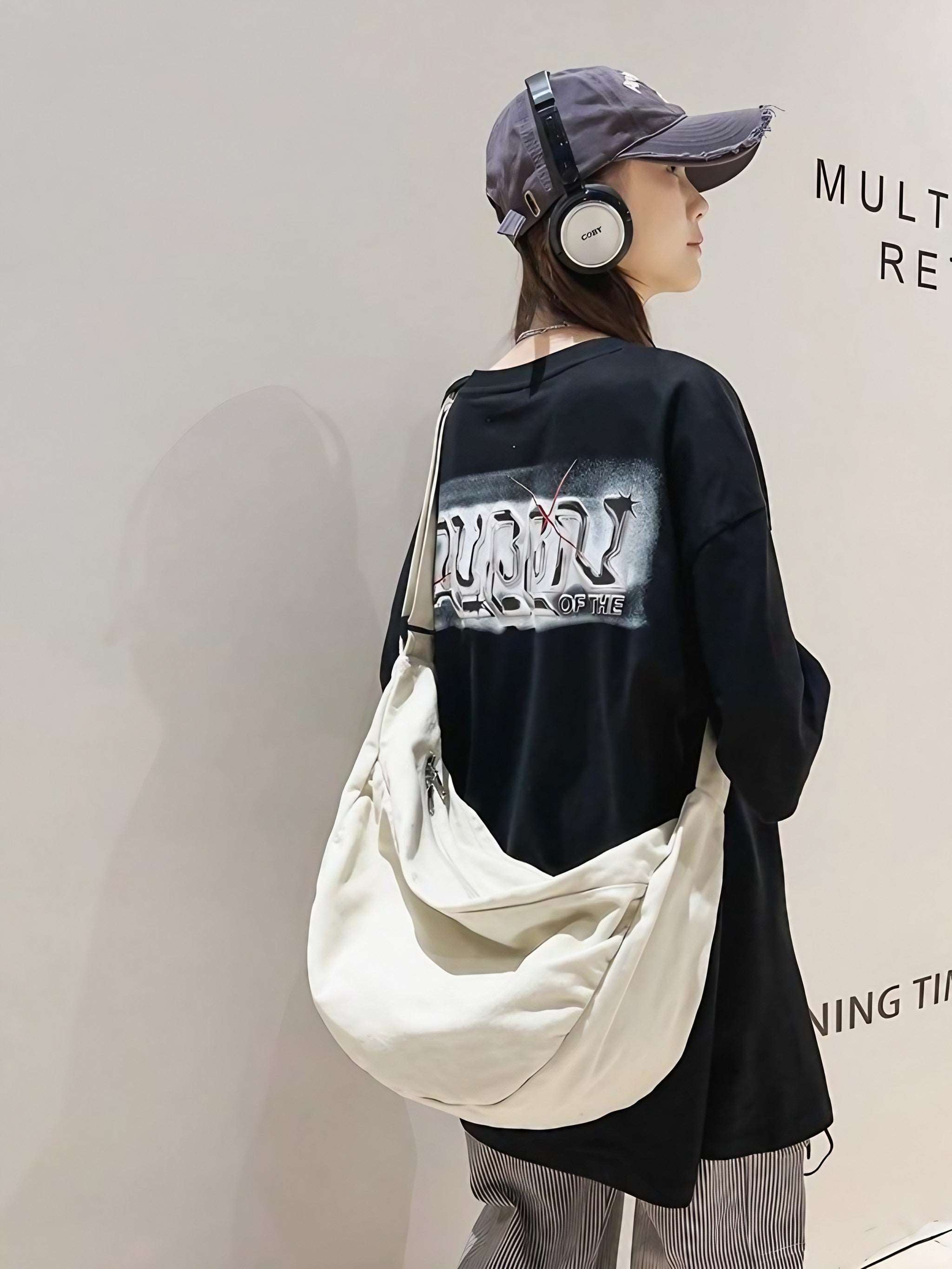 Fashionable woman with headphones accessorizing with a white leisure bag