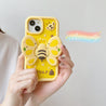 Woman displaying a vibrant yellow iPhone case adorned with a butterfly motif