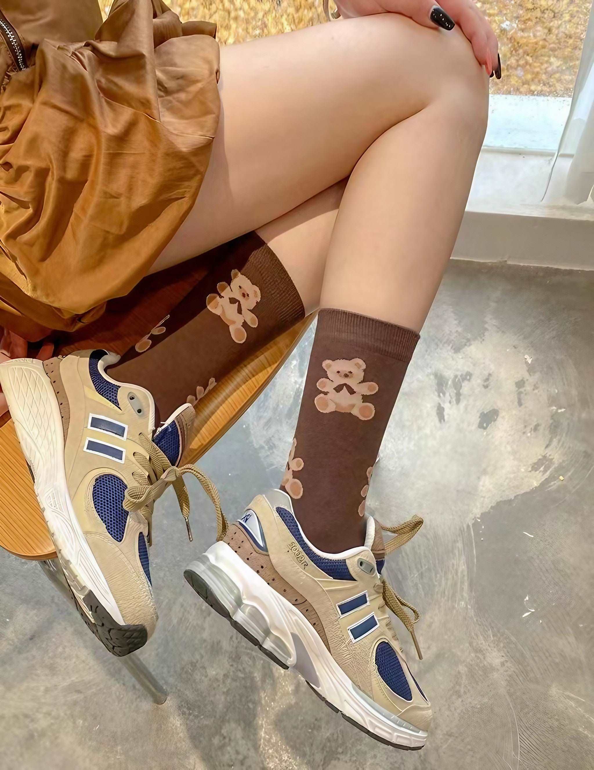 Close-up of a woman's feet wearing brown bear print socks from the 1+2 Socks Set