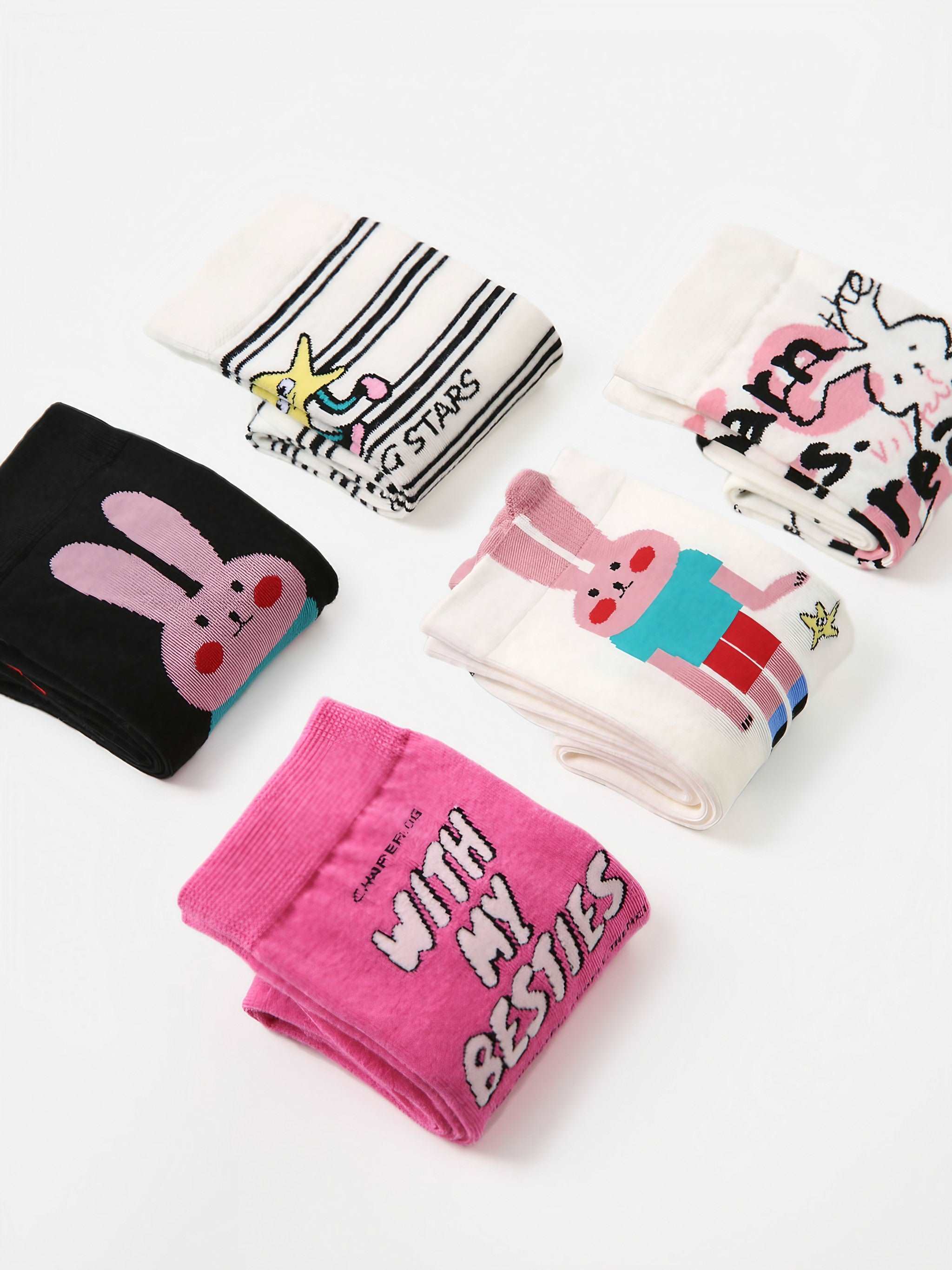 A collection of five pairs of socks with various cartoon prints displayed