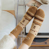 Comfortable winter socks with a bear design worn by a woman