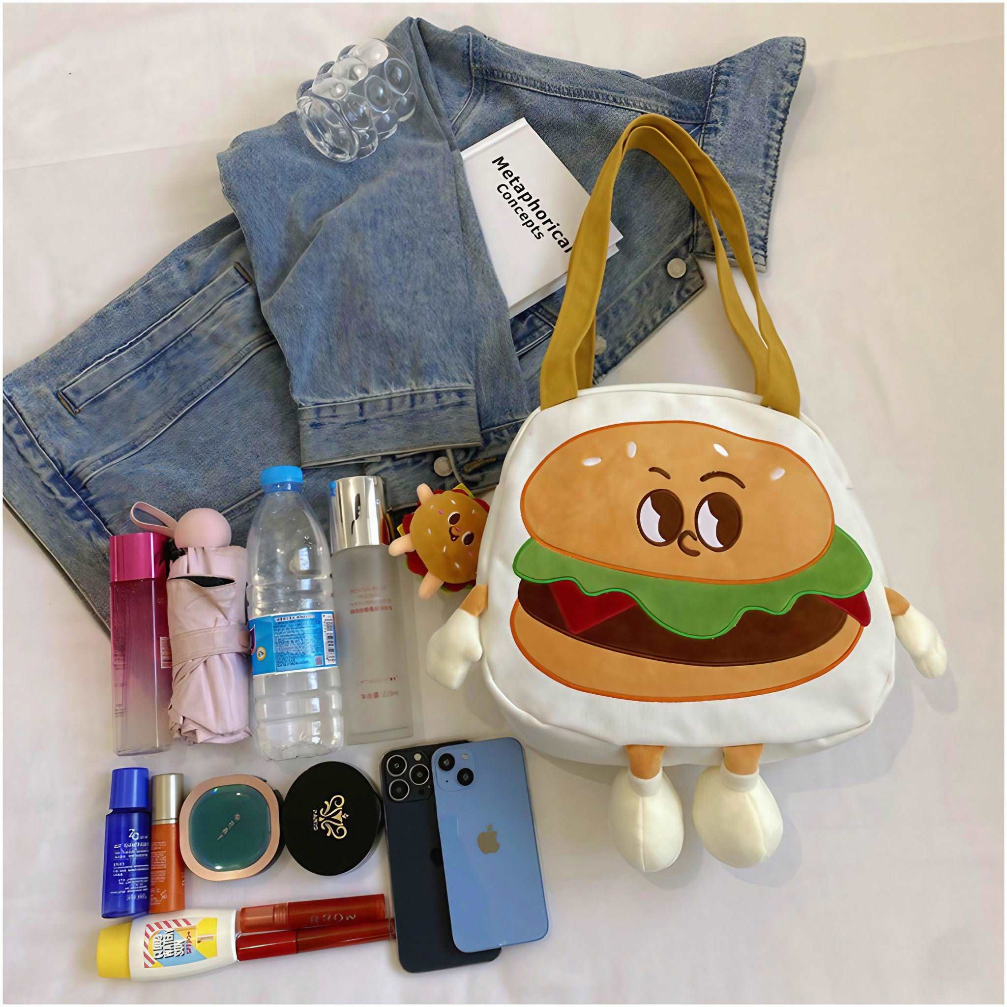 Hamburger-shaped bag accessorized with essentials like phone and wallet