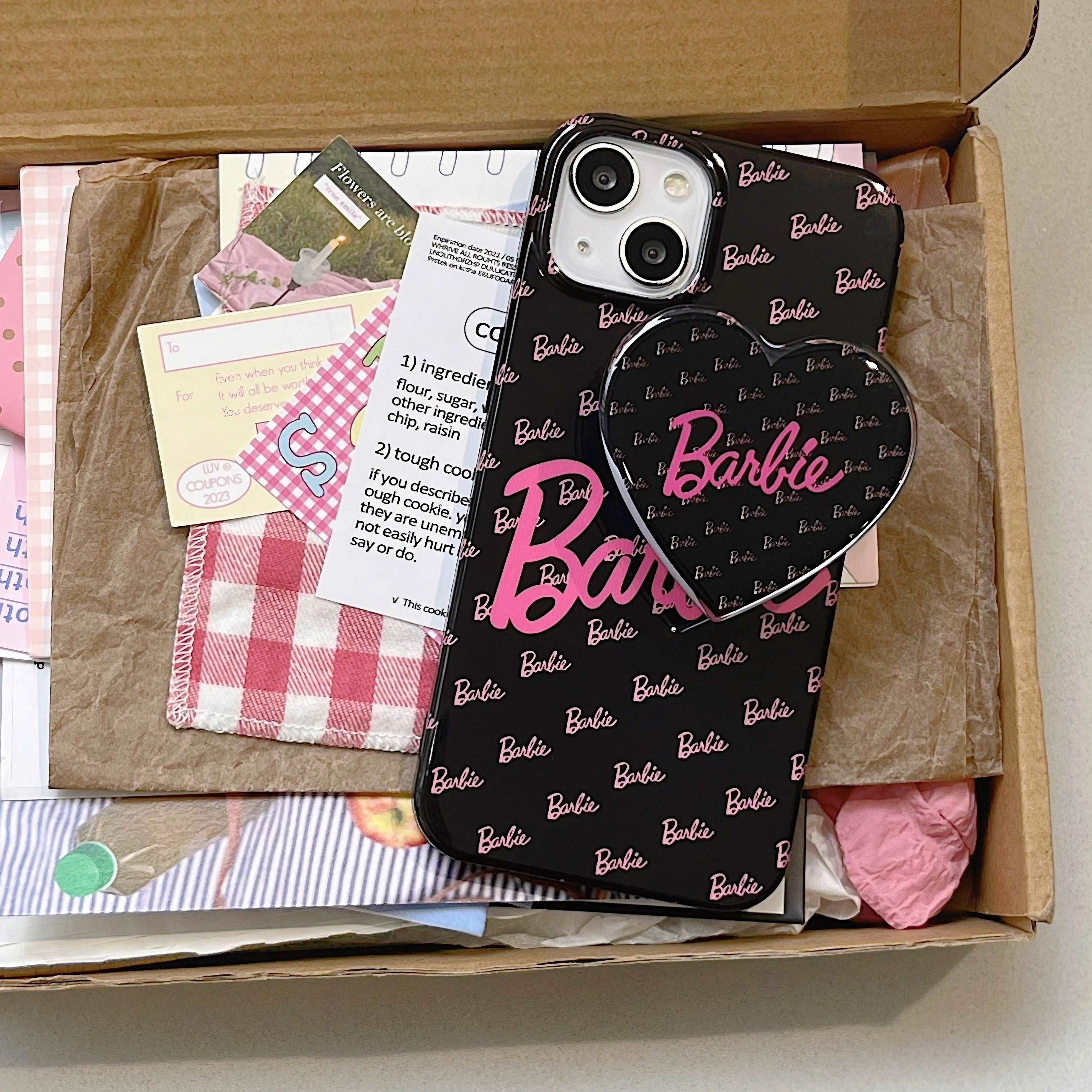 Packaging of the Barbie iPhone case with a phone stand and heart motif