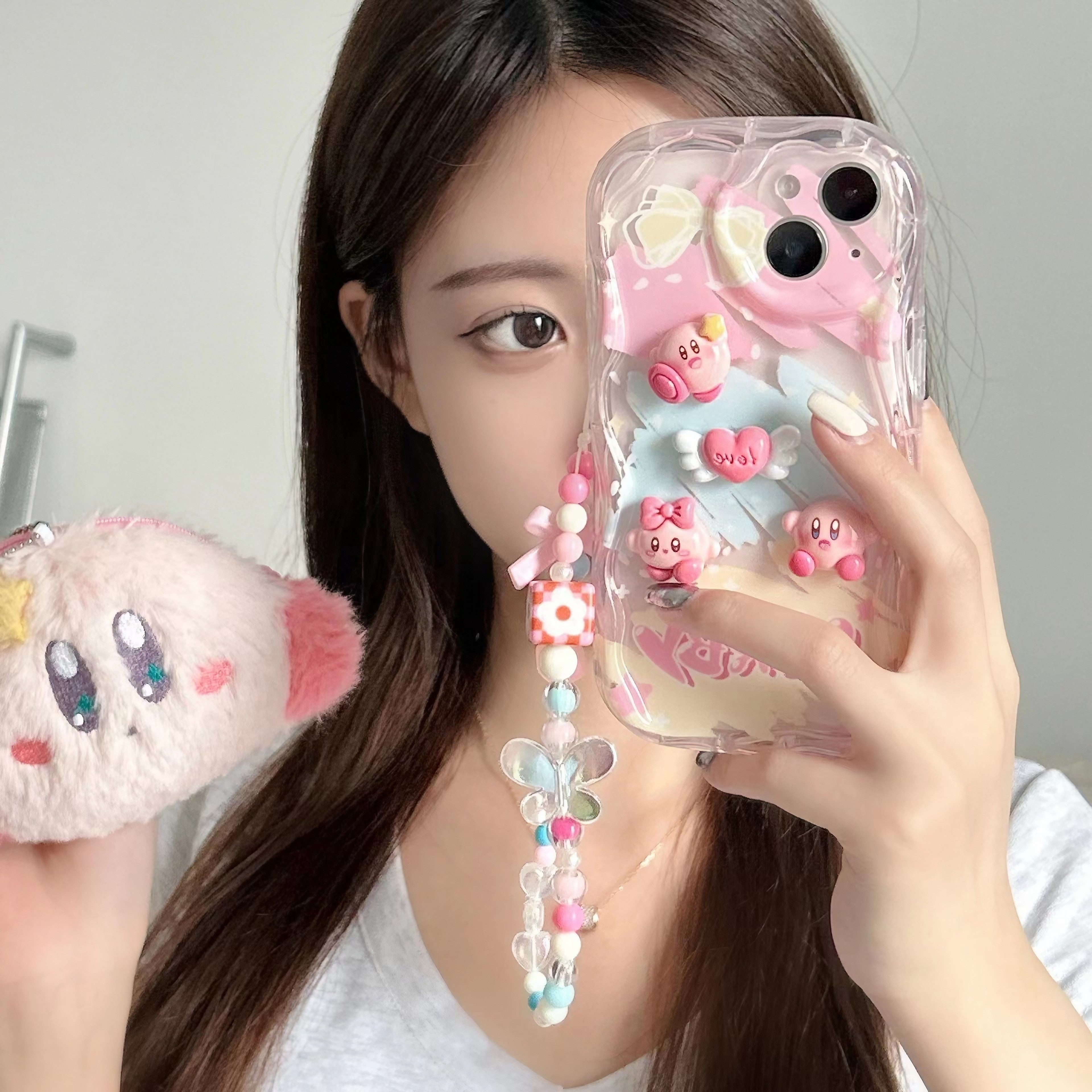 Individual showcasing a Kirby soft TPU case for iPhone 13 Pro Max in a pastel pink hue