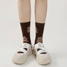 Casual style with white sneakers paired with the warm Brown Bear Socks