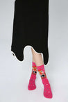 Fashionable woman in a black skirt highlighting her Blackpink pink socks