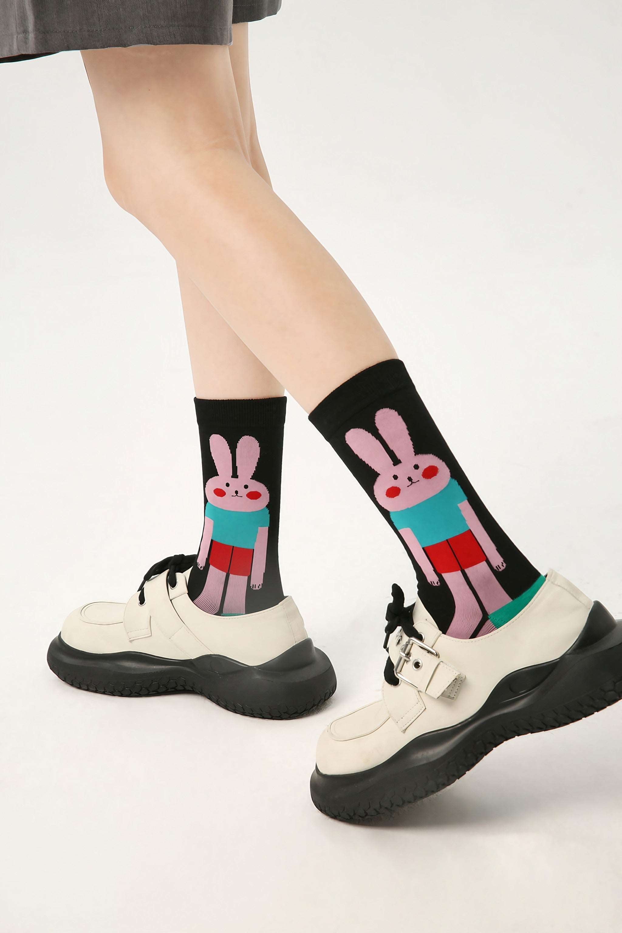 Stylish black socks with a rabbit motif worn by a woman