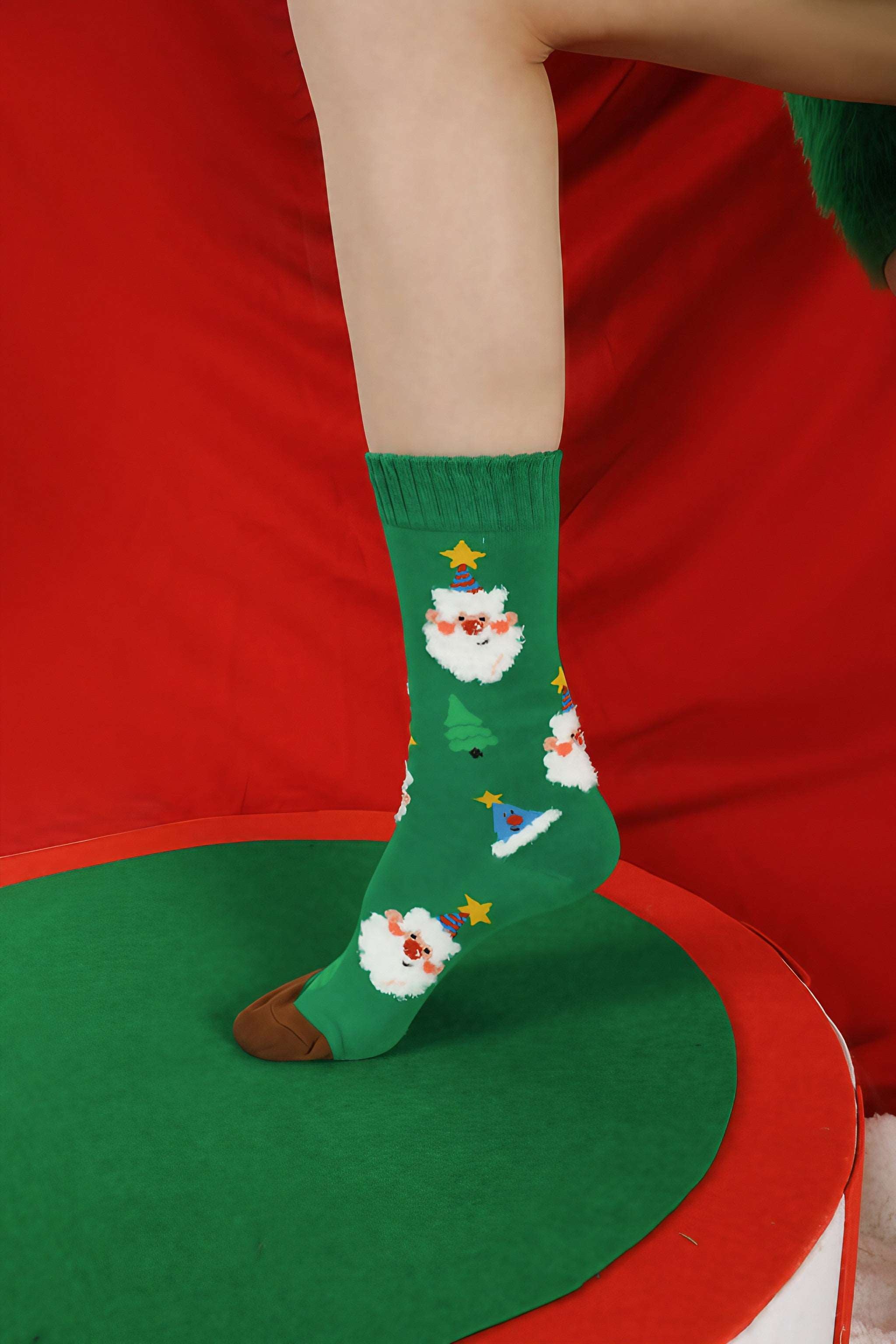 Green socks with a Santa Claus print worn by a woman