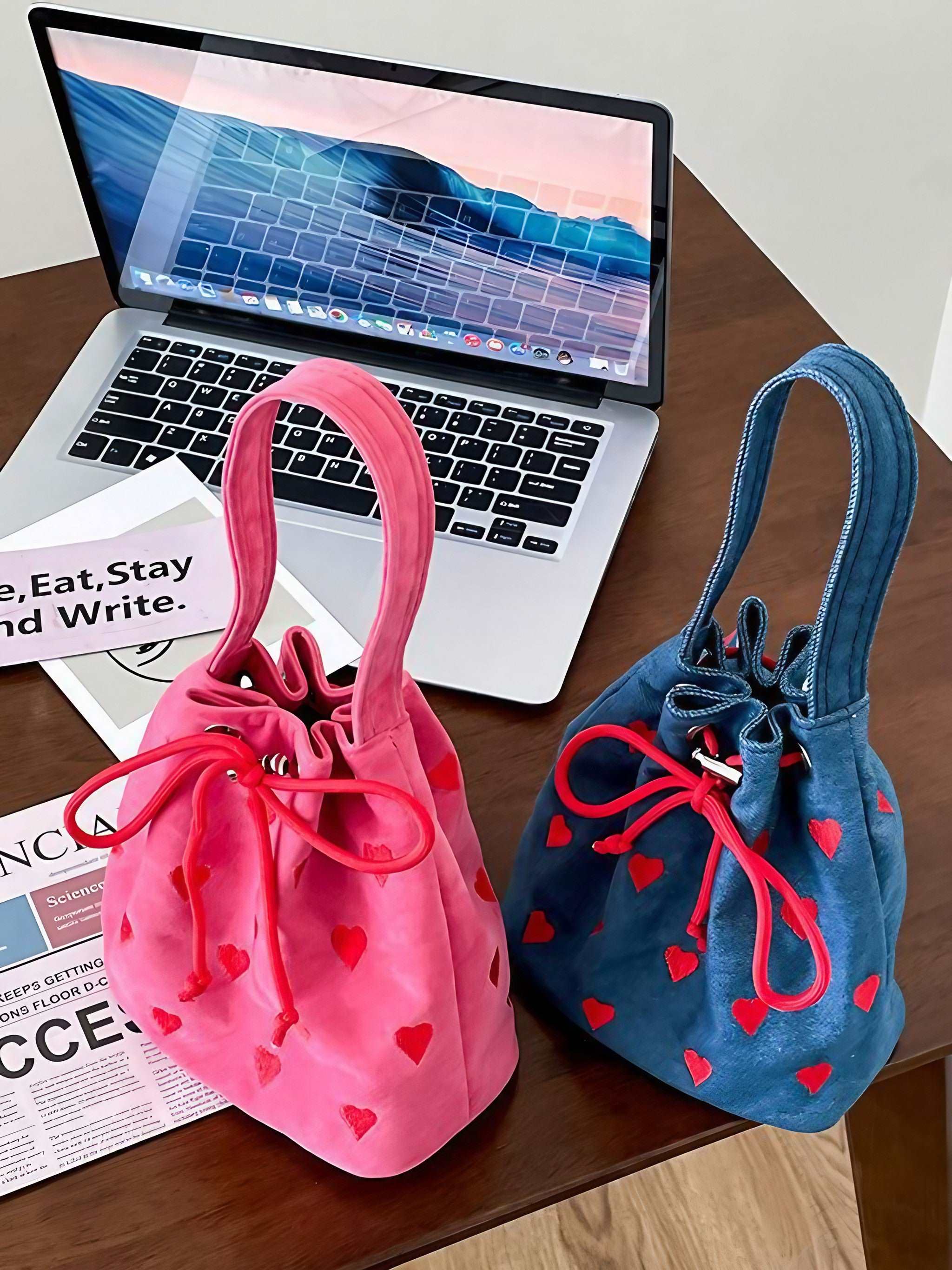 Mini denim handbags with heart designs placed on a surface