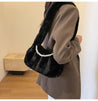 Chic black plush bag adorned with pearl details