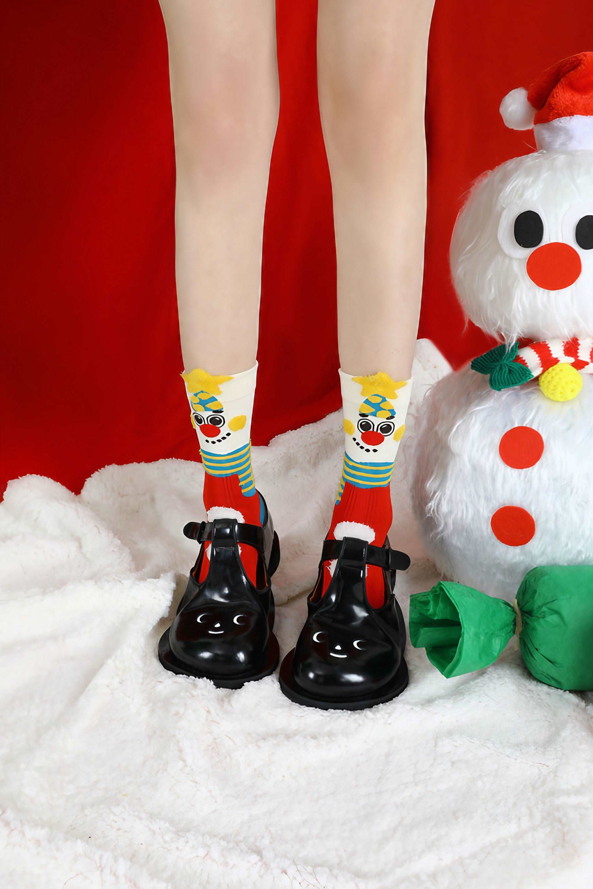 Cozy winter socks with a snowman design, paired with black shoes