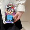 Hand holding an iPhone adorned with a Dr. Slump Arale character case