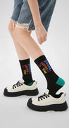 Black socks featuring vibrant Tektonik lettering from the Blackpink Purple collection