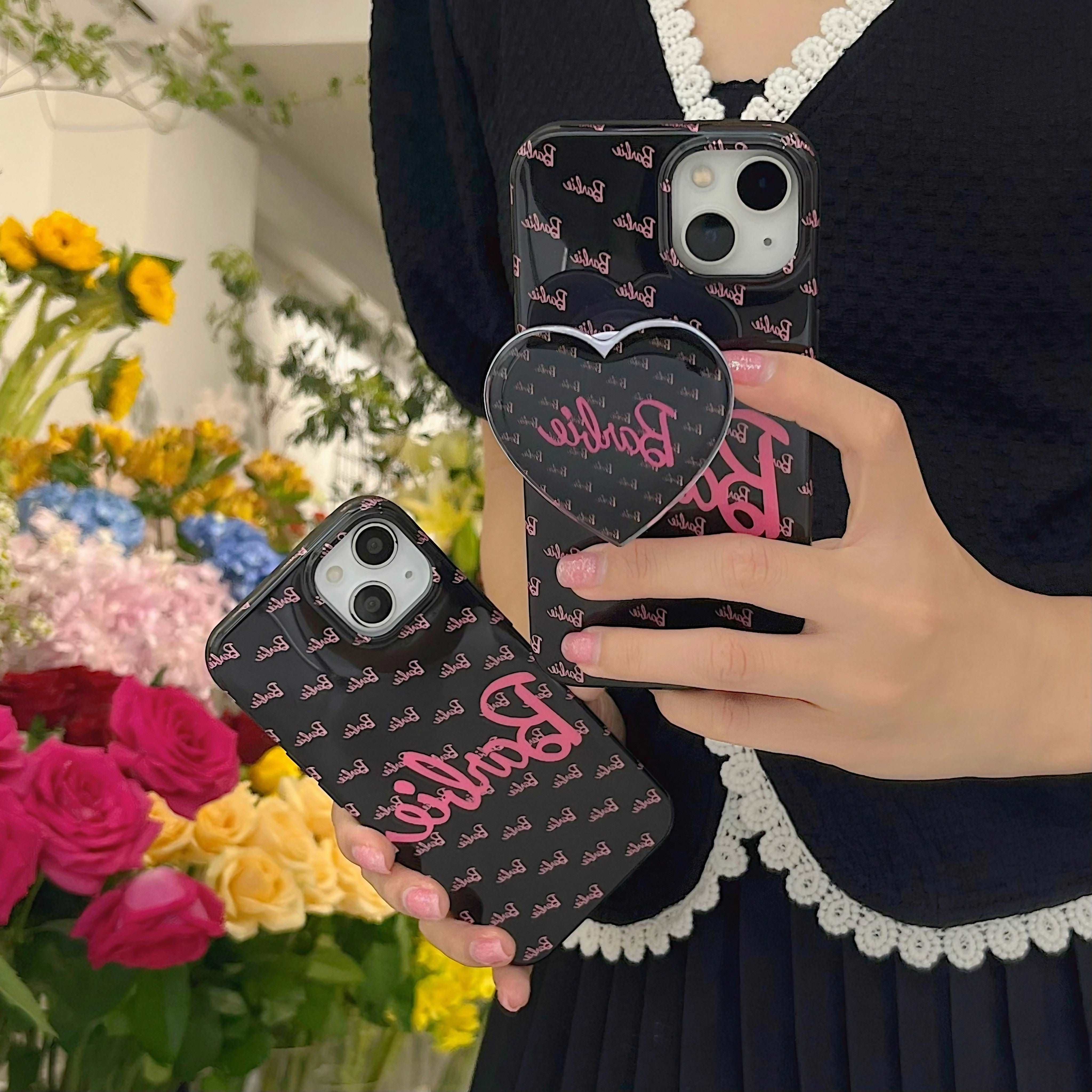 Display of two iPhones with 'Barbie' cases, part of the Blackpink Barbie collection