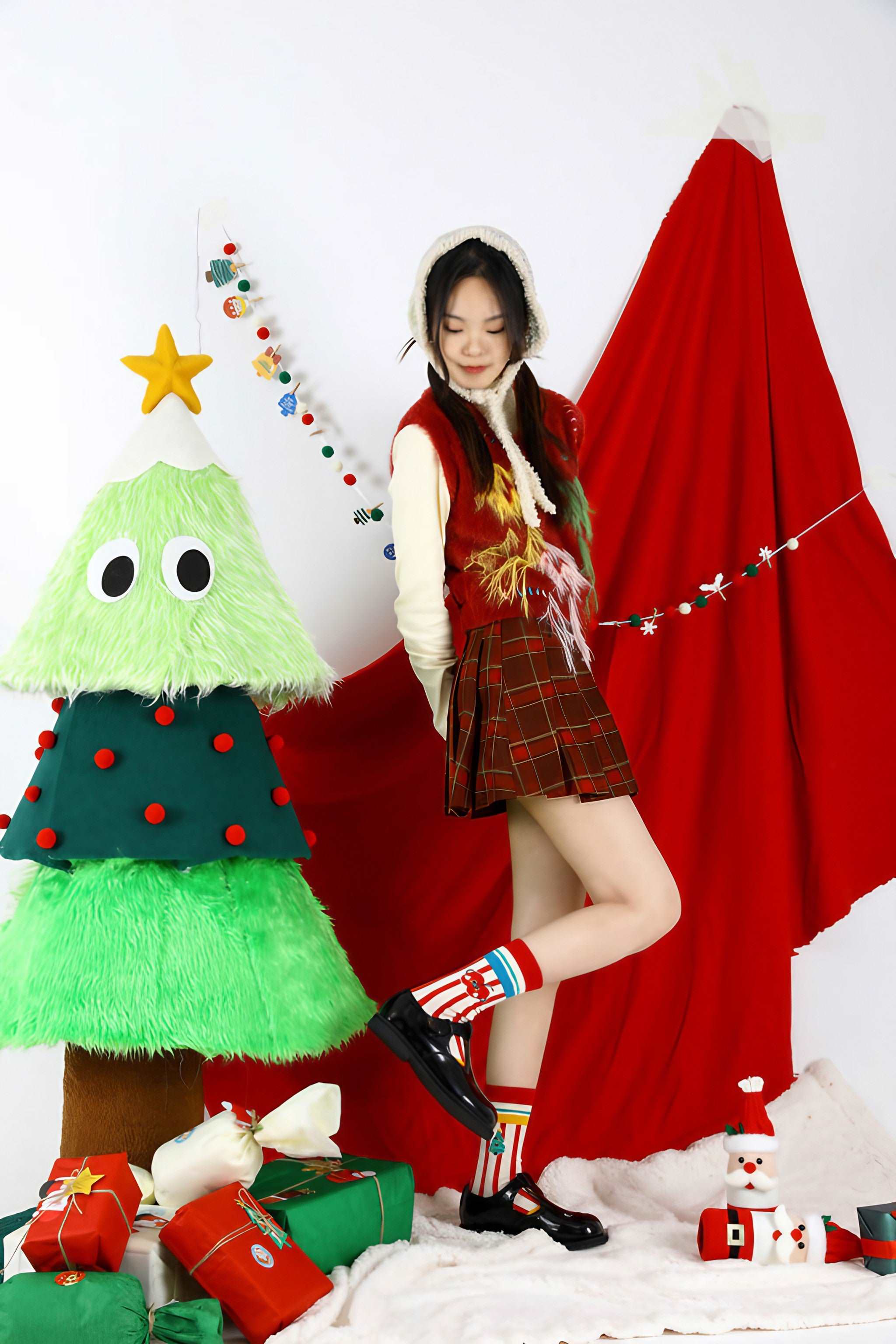 Elegant woman wearing festive Christmas socks by a decorated Christmas tree