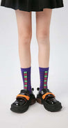 Trendy purple Tektonik socks complemented by black footwear on a young girl