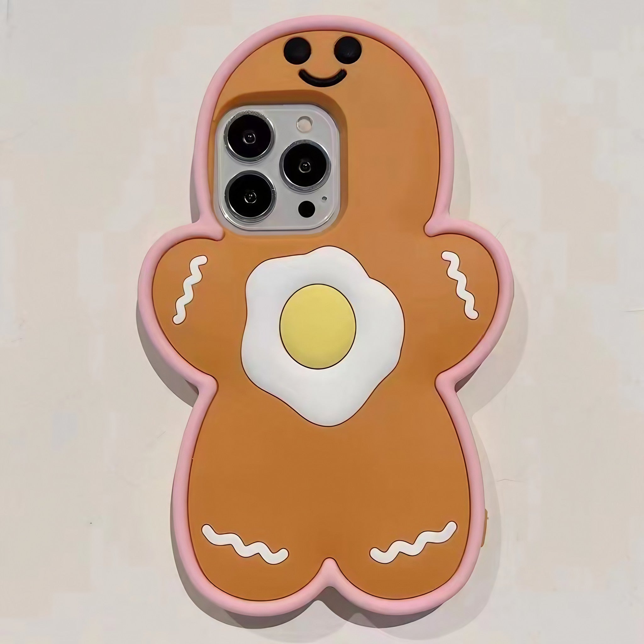 Close-up of a gingerbread man illustration on an iPhone case with a decorative egg accent