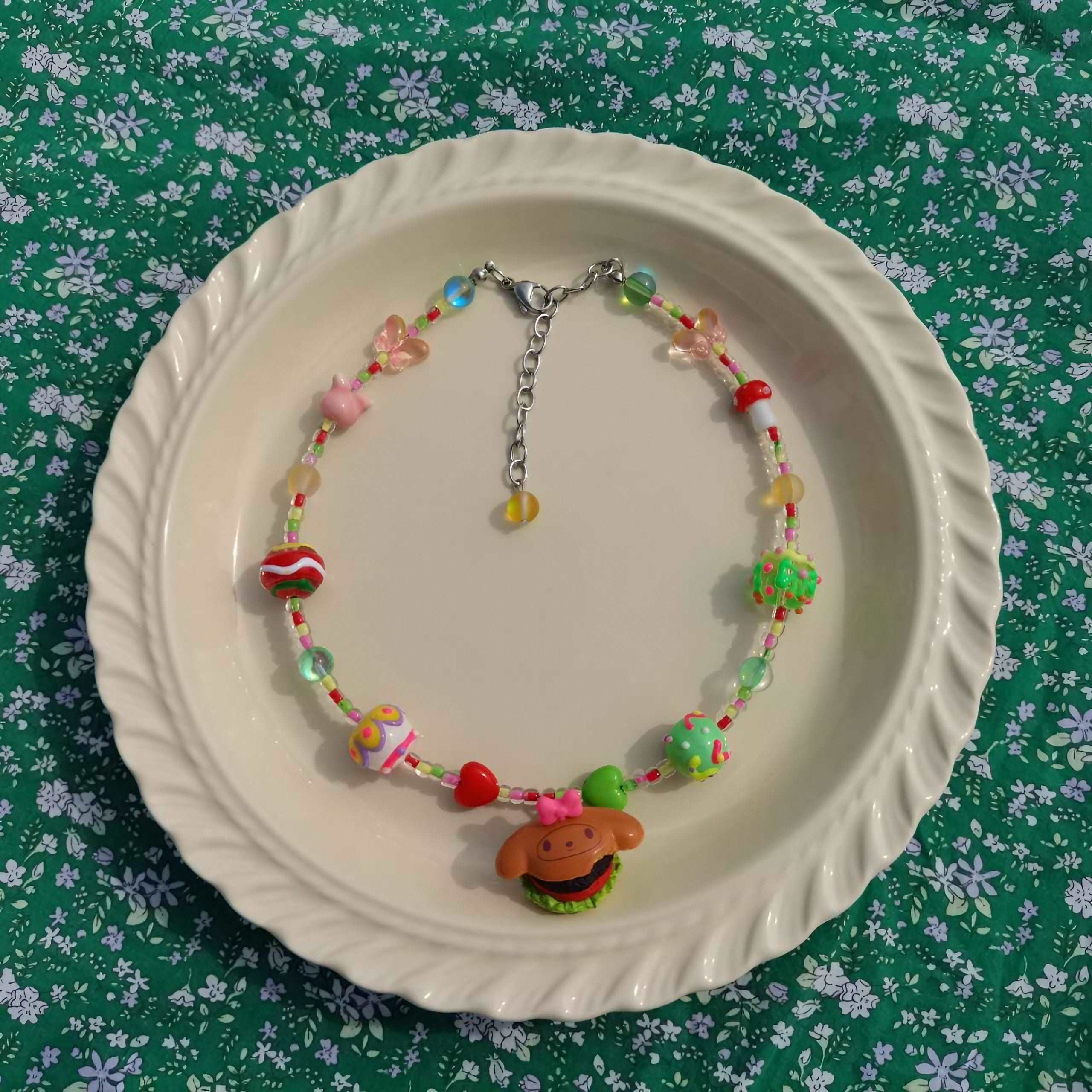 Handmade My Melody style brown necklace displayed on a plate