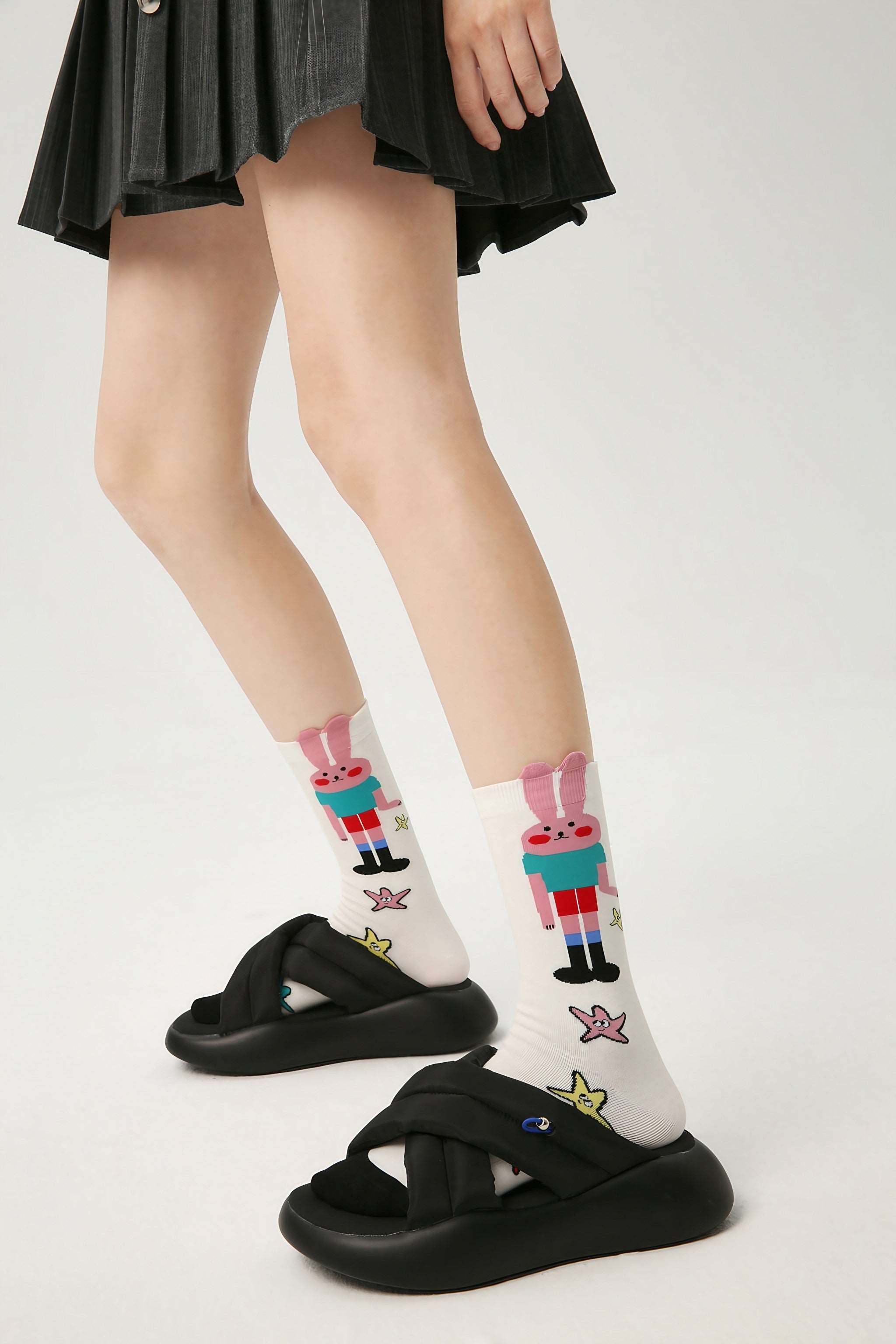 Stylish woman pairing her skirt with cartoon rabbit socks